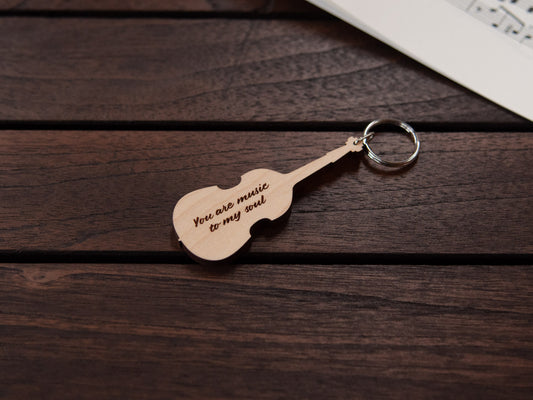 A double bass shaped keychain made from maple wood, with personalized engraving