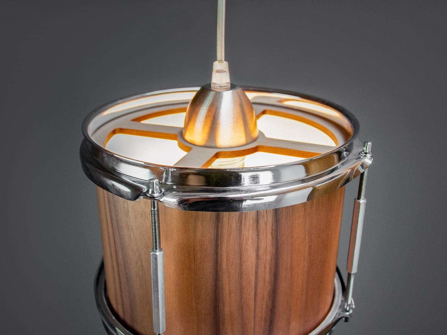 Top view of a pendant light made from a drum, finished with a rich walnut veneer