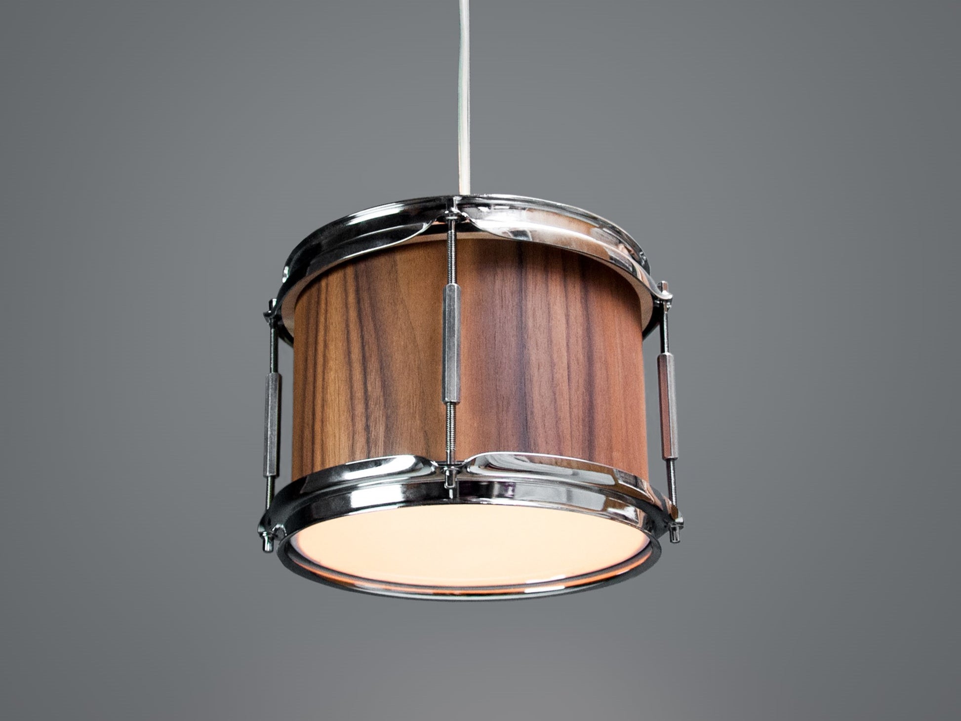 Middle-bottom view of a pendant light made from a drum, finished with a rich walnut veneer