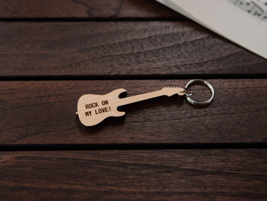 A maple wood keychain in the shape of an electric guitar