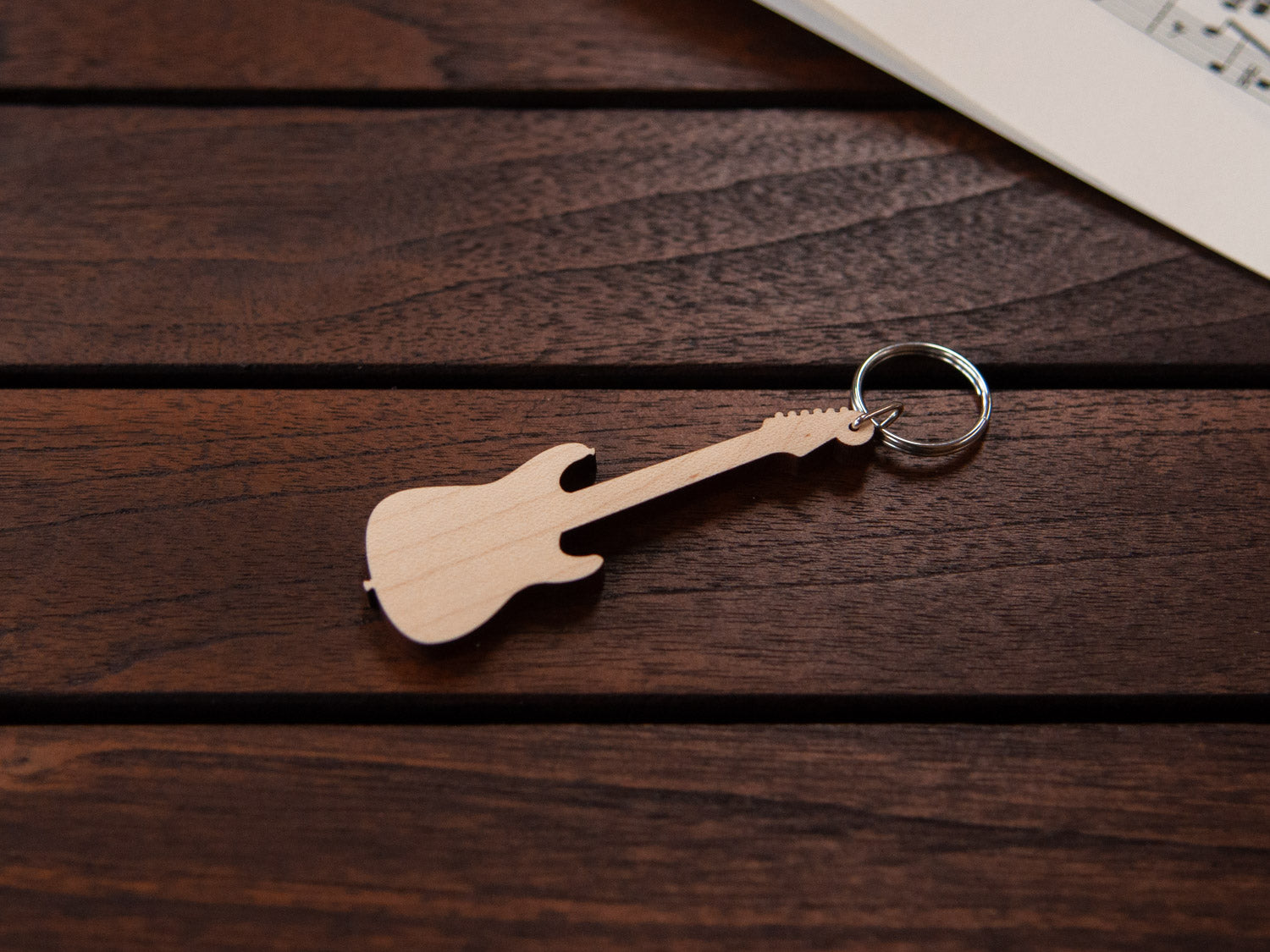 A maple wood keychain in the shape of an electric guitar