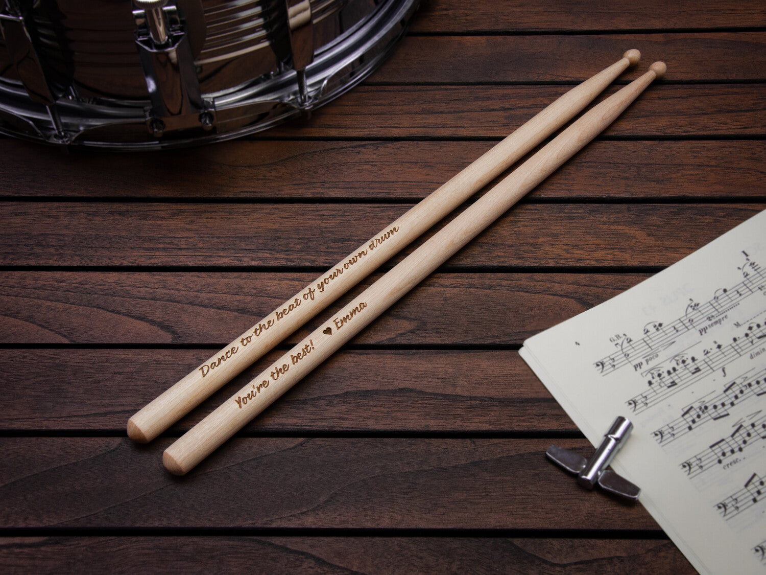 wooden drumsticks with a personalized message engraved on them