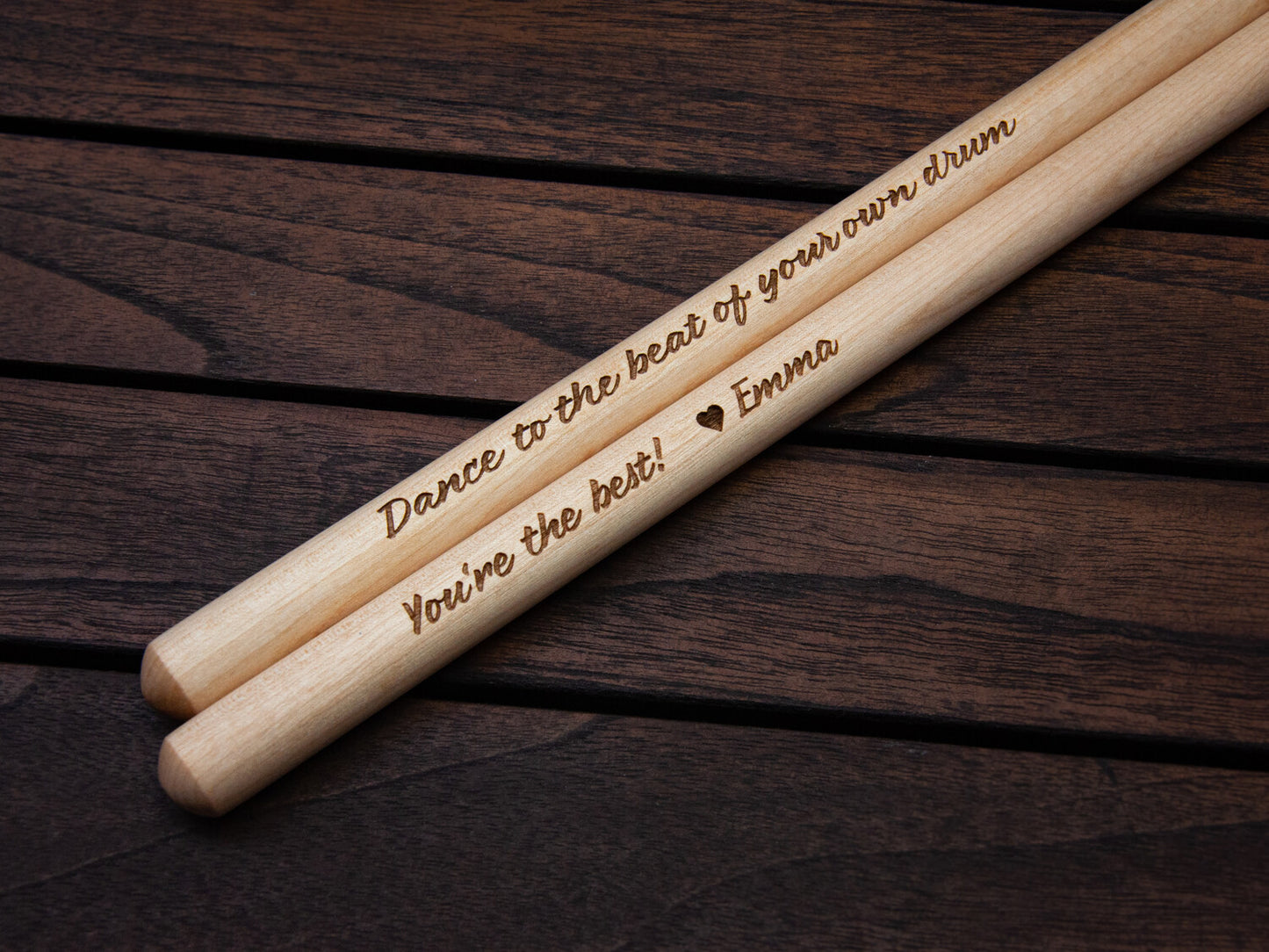 details of engraved drumsticks, showing a personal message