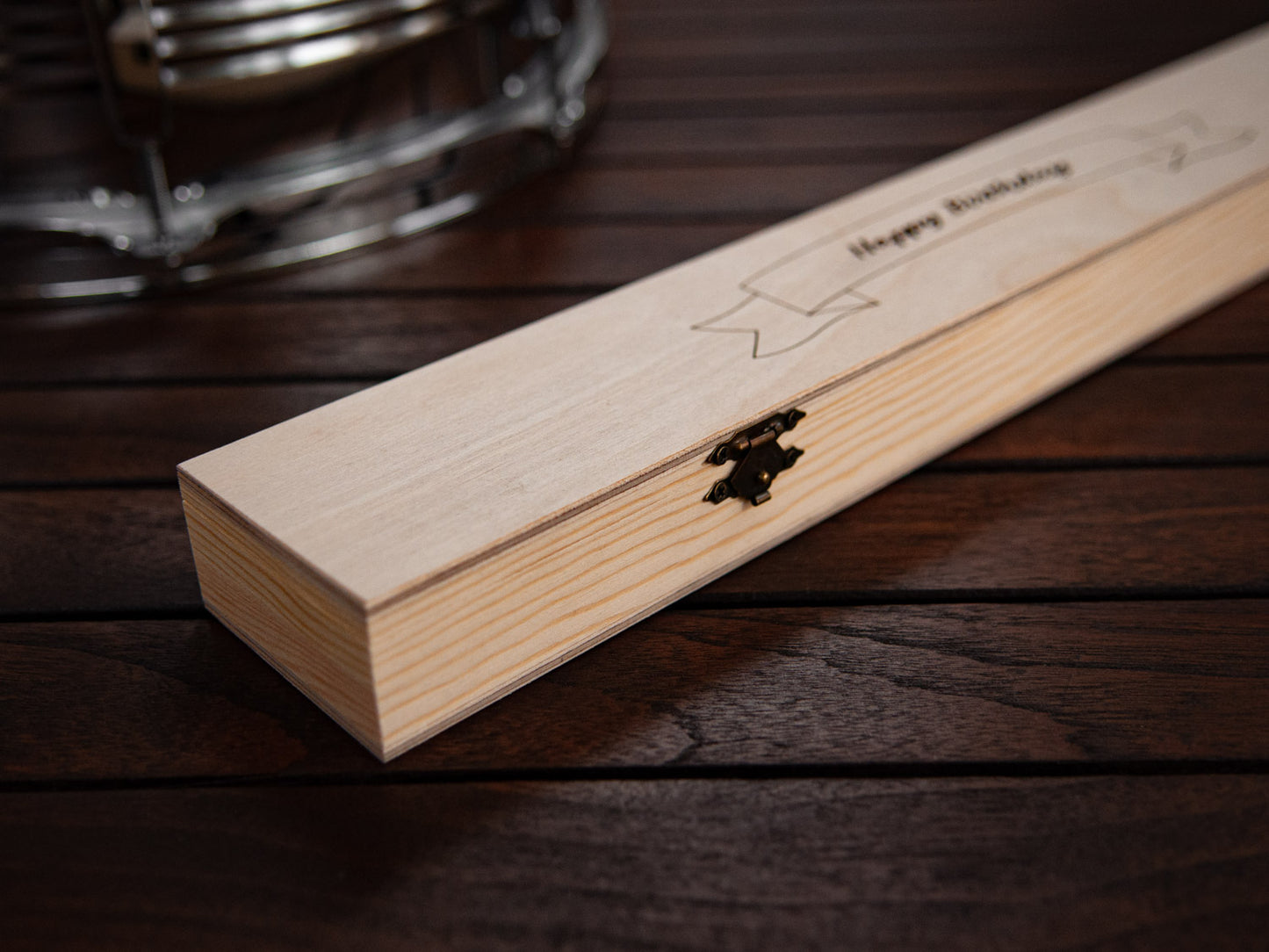 details of a wooden box, which is made to hold engraved drumsticks