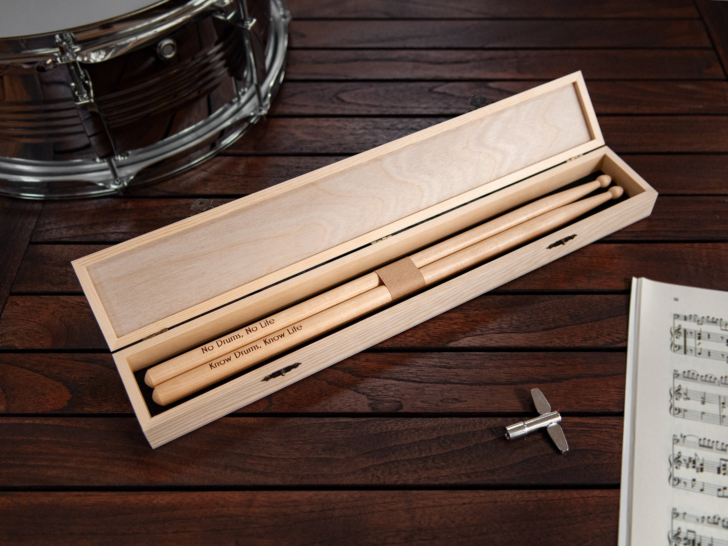 Engraved drumsticks presented in a wooden box