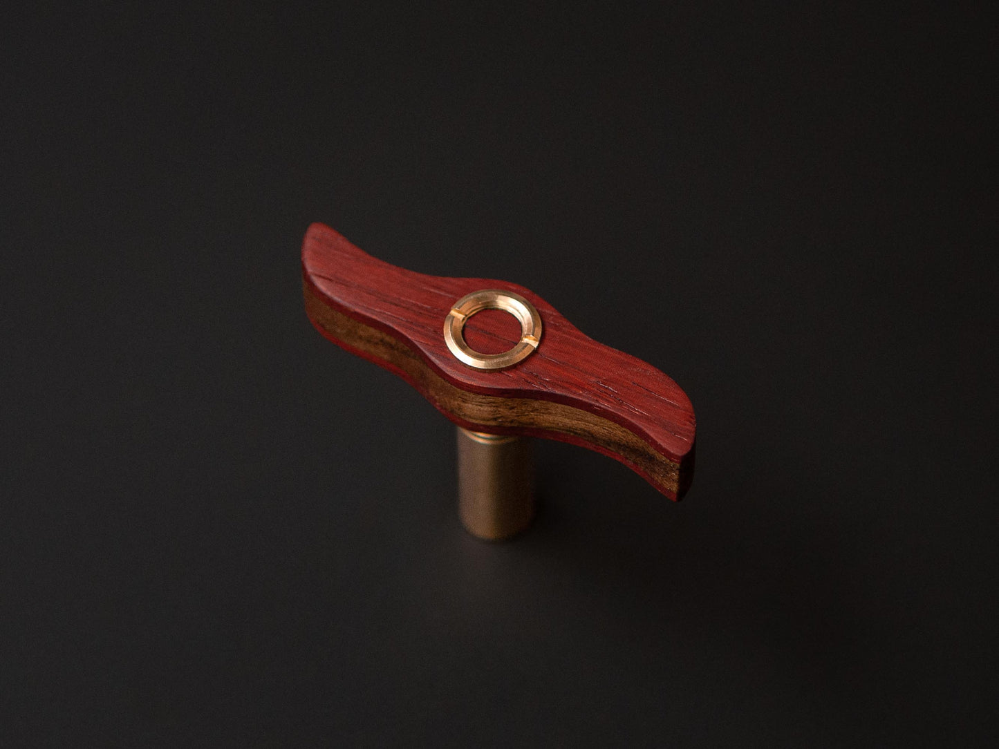 Topview of a handmade drum key, with padauk and brass details