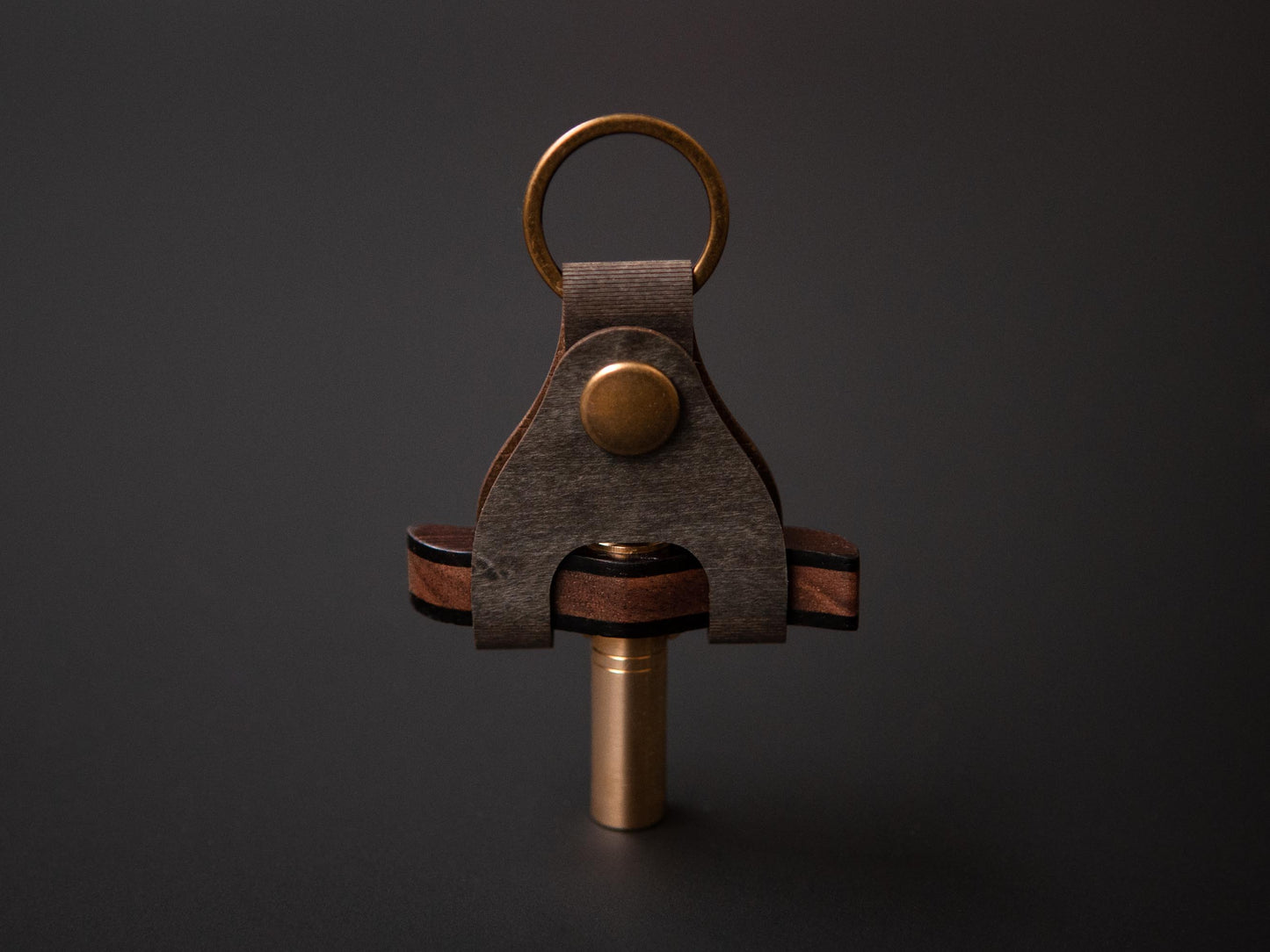 A handcrafted drum key made from walnut, wenge and brass in its tailor made case