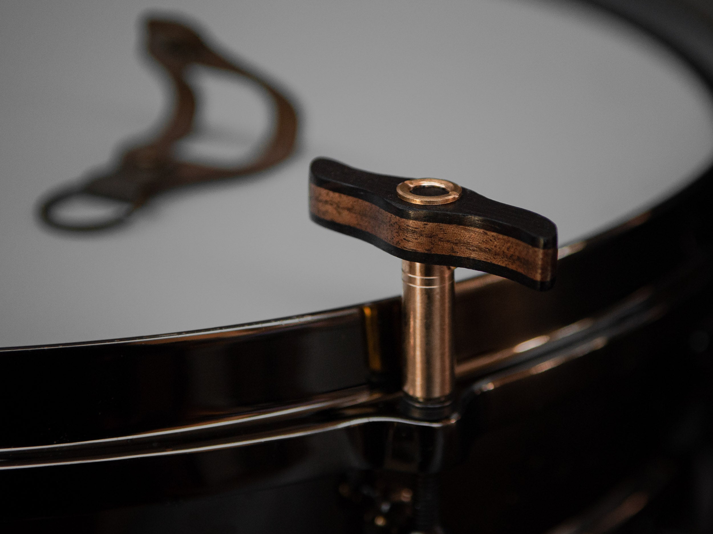 Drum key made from walnut and wengé wood, with brass details