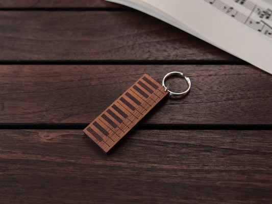 A keychain designed like a the keys of a piano, crafted from walnut and wenge wood