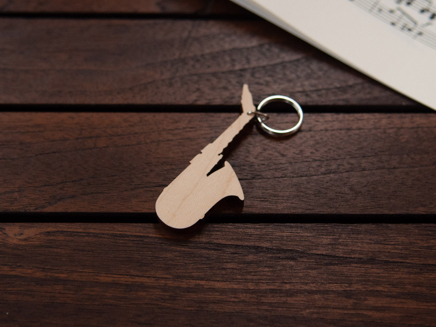 A maple wood keychain in the shape of a saxophone