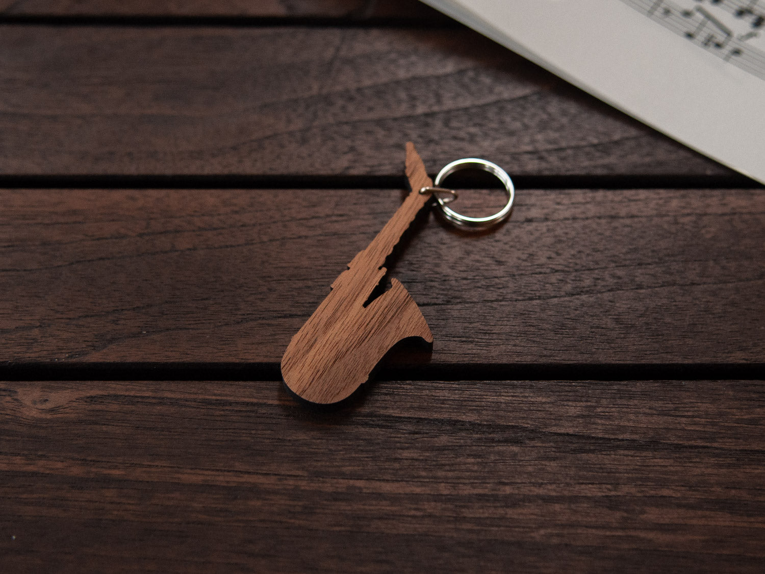 A maple wood keychain in the shape of a saxophone