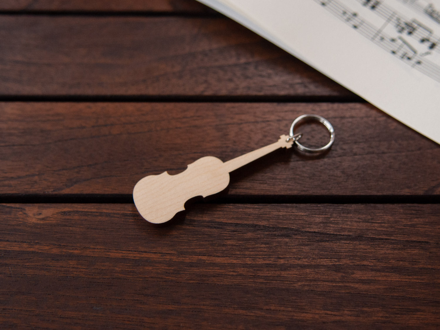 A maple wood keychain in the shape of a violin